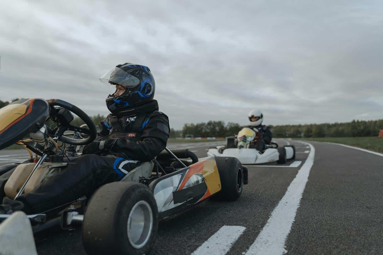 Competitive go-kart race with drivers in action on a challenging outdoor circuit.